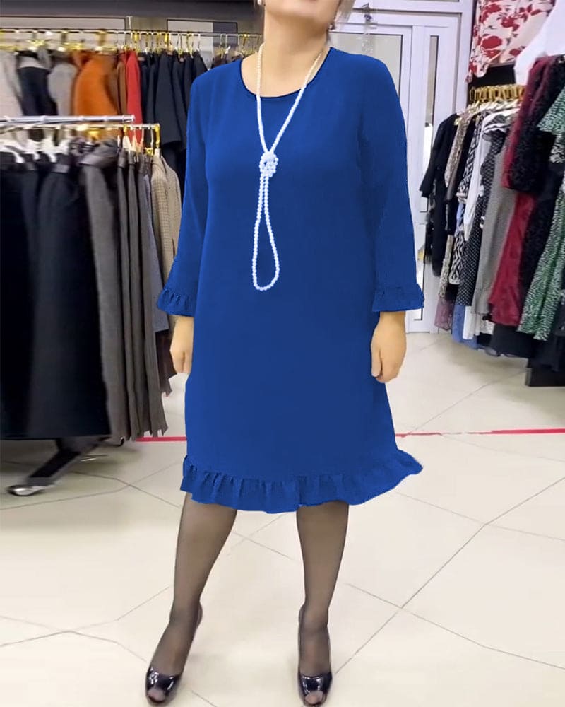Laura - Een geplooide patchwork jurk in één effen kleur