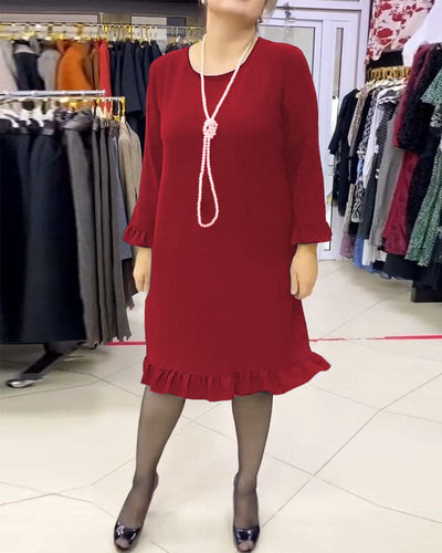 Laura - Een geplooide patchwork jurk in één effen kleur